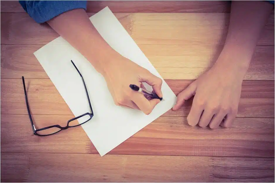 man writing a list of questions to his dr. for LASIK