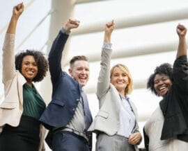 business casual people posing with fists in aie