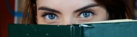 Close up of woman's eyes reading book