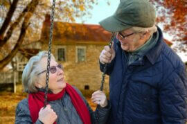 mature couple at swing set