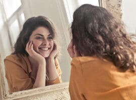 woman looking in mirror