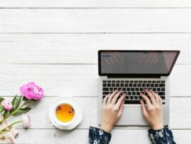 woman on laptop on picnic table from above