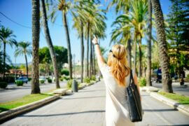 woman pointing at palm trees